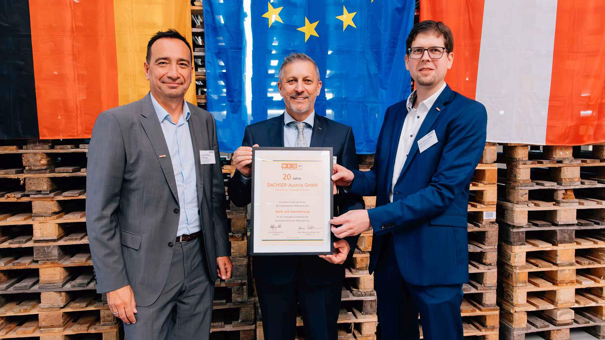 Mario Freiberger, Head of the Schwechat branch of the Lower Austrian Chamber of Commerce, (left) and Mathias Past, Chairman of the Schwechat branch of the Lower Austrian Chamber of Commerce, (right) presented G&uuml;nter Hirschbeck, Managing Director European Logistics Austria, with a certificate to mark the 20th anniversary of DACHSER Austria.
 